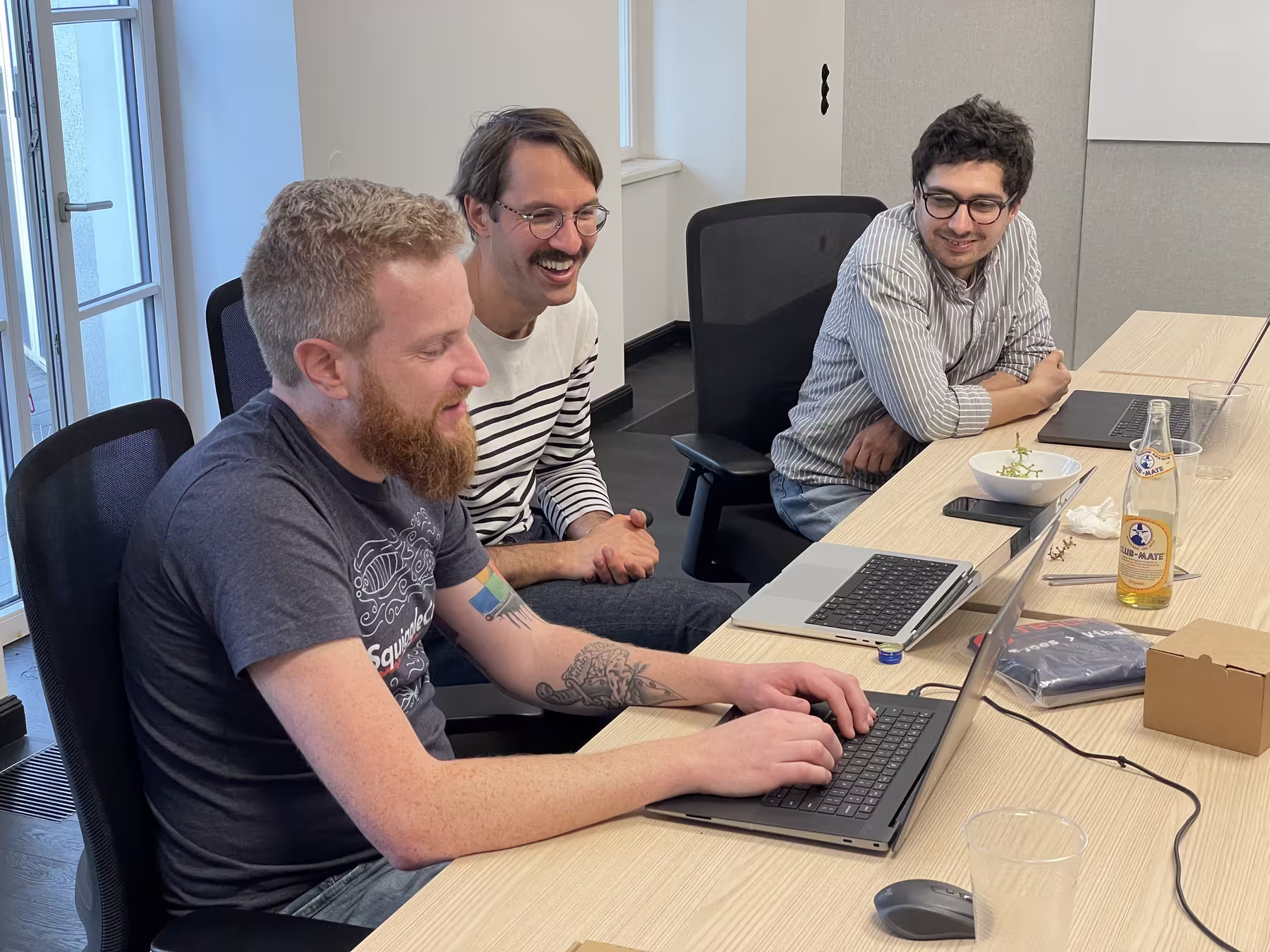 ReScript contributors discussing implementation details at a table